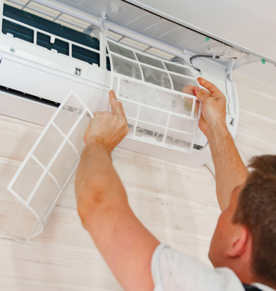 Man servicing a wall mounted air conditioner