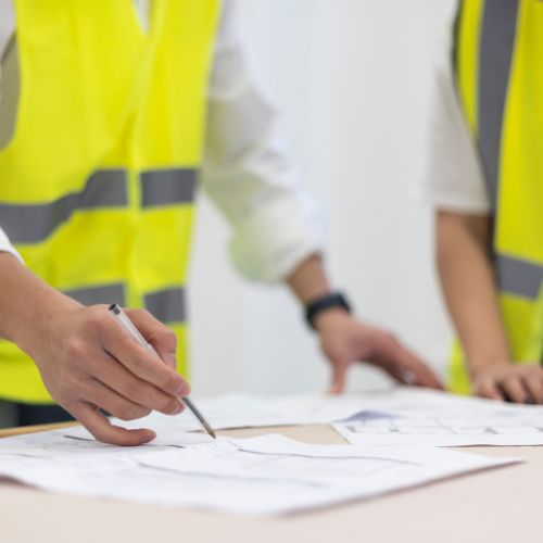 two people in his vis looking at plans