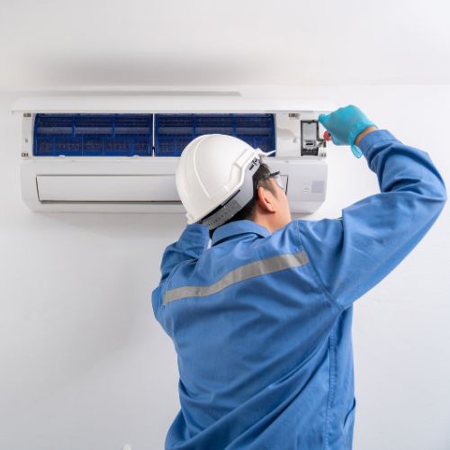 man installing an air con unit