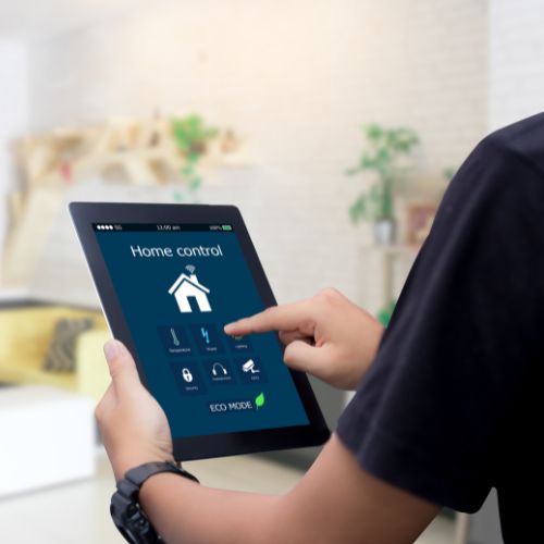 person looking at a tablet with smart home capabilities