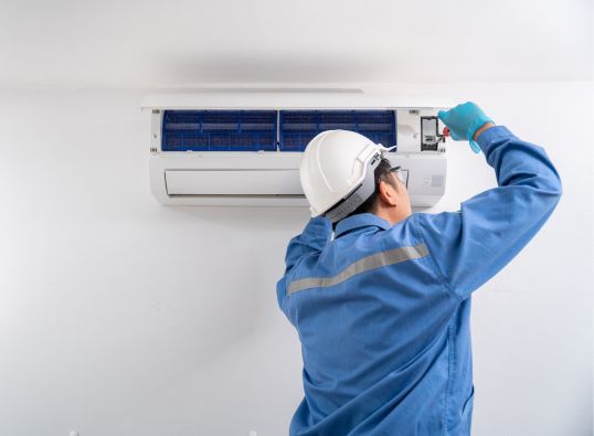 man doing air conditioning maintenance